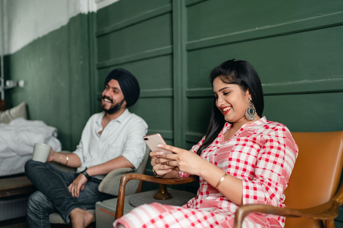 Two creators smiling at a phone